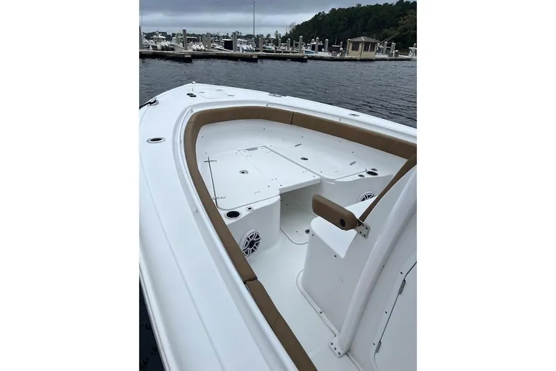 Wrecking Ball Yacht Photos Pics 2023 Sea Hunt Ultra 305 SE boat with spacious deck and seating at marina.