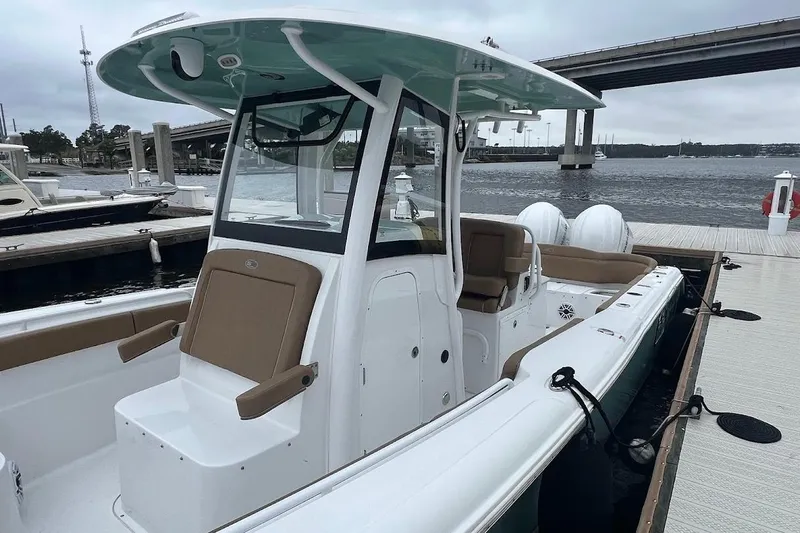 Wrecking Ball Yacht Photos Pics 2023 Sea Hunt Ultra 305 SE boat docked by the waterfront, showcasing sleek design.