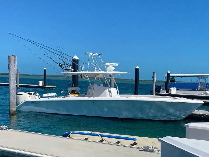 2004 Venture 34 Center Console boat docked at a marina on a sunny day.