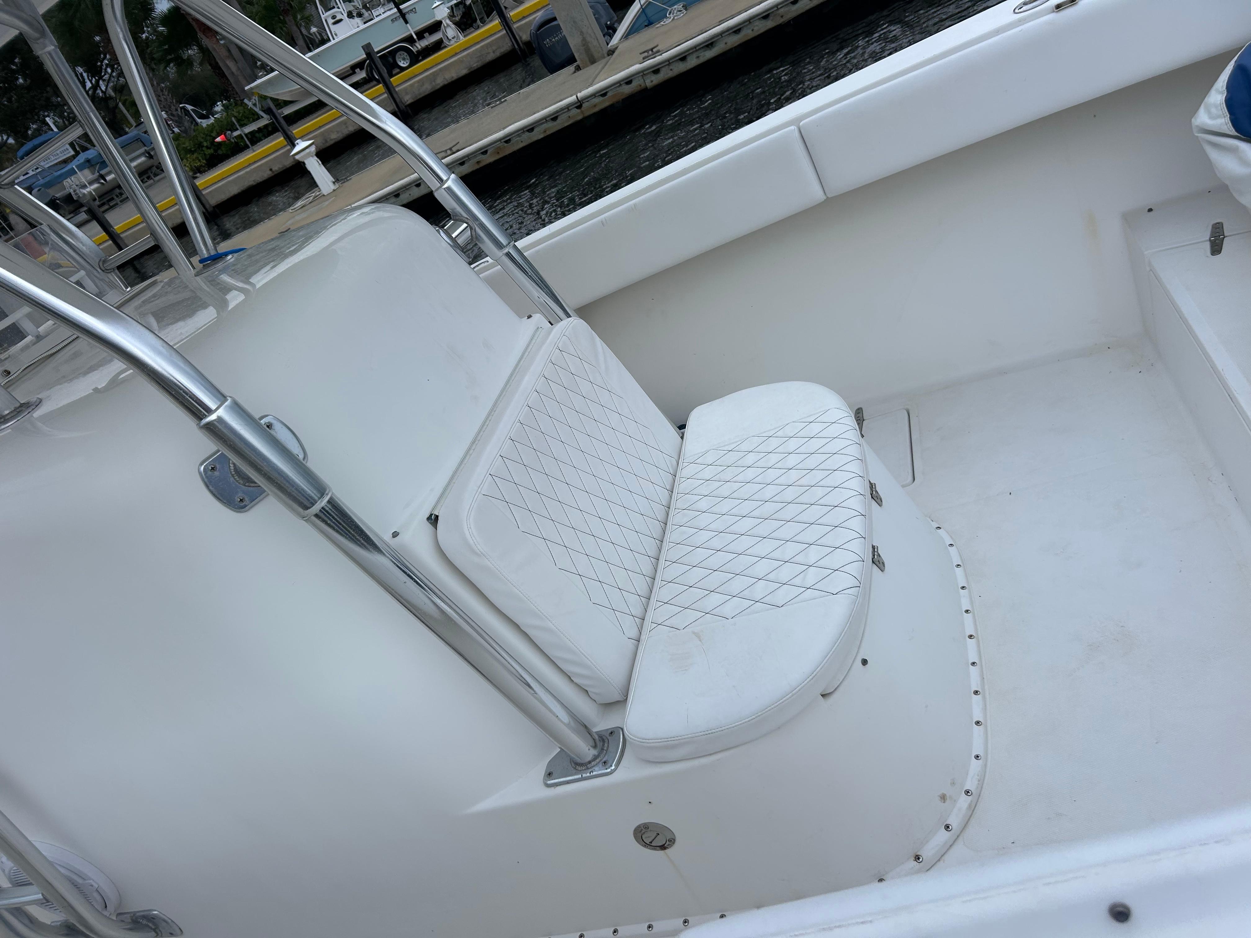 2004 Venture 34 Center Console boat interior with white cushioned seating.