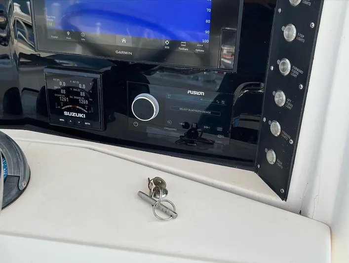 Growing Grass Yacht Photos Pics 2004 Venture 34 Center Console dashboard with Garmin, Suzuki, and Fusion electronics.