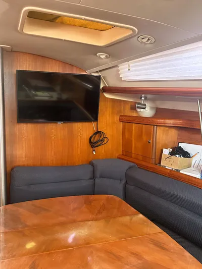 Top Dog Yacht Photos Pics Interior of a 2006 Hunter 38 Ft Sloop with TV and seating area.
