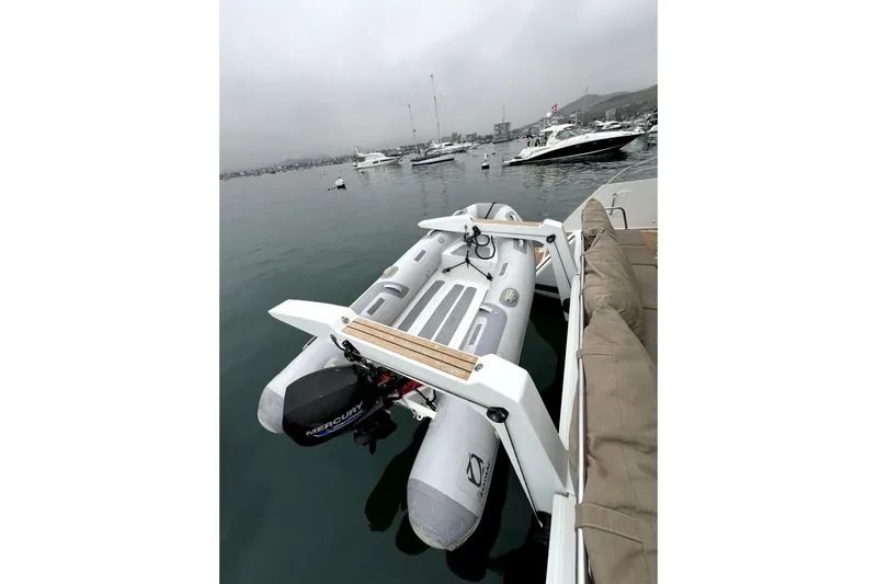 4life Yacht Photos Pics Inflatable boat with Mercury motor on 2016 Fountaine Pajot SABA 50 catamaran, docked in marina.