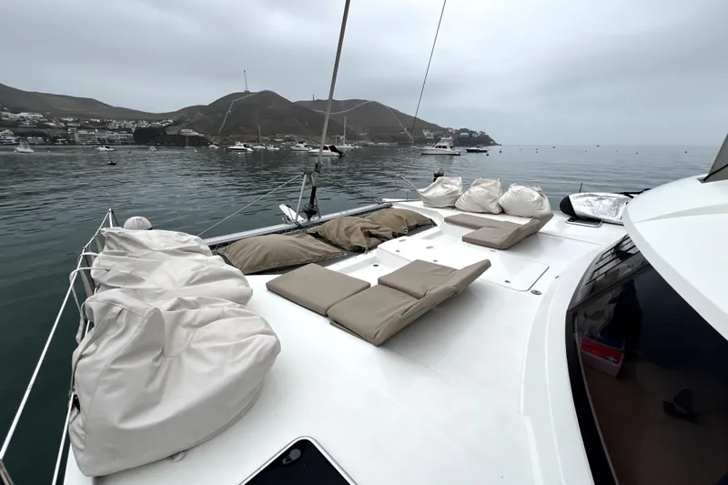 4life Yacht Photos Pics 2016 Fountaine Pajot SABA 50 yacht with cushioned deck, anchored in scenic bay.