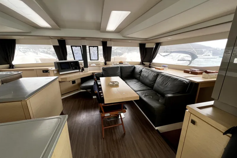 4life Yacht Photos Pics Luxurious interior of 2016 Fountaine Pajot SABA 50 catamaran with modern furnishings and panoramic windows.