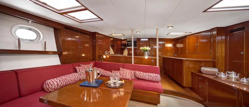 Atalanta J Yacht Photos Pics Luxurious interior of 1958 Feadship ATALANTA J yacht with elegant wood paneling and plush seating.