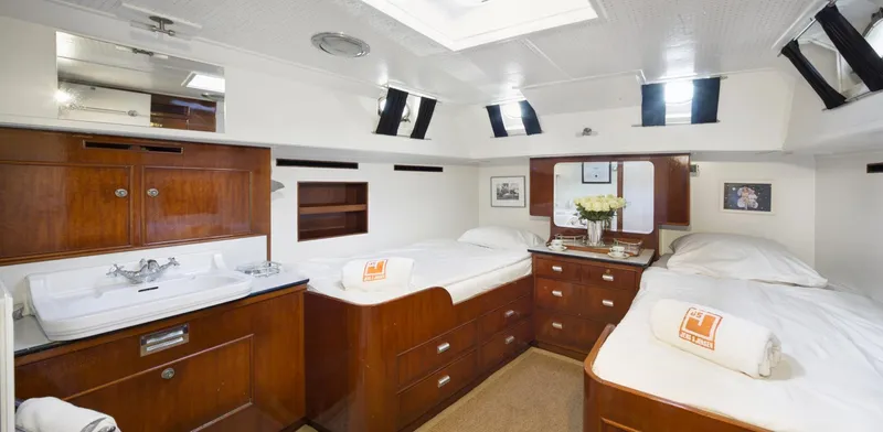 Atalanta J Yacht Photos Pics Luxurious cabin interior of 1958 Feadship ATALANTA J yacht with twin beds and wooden furnishings.