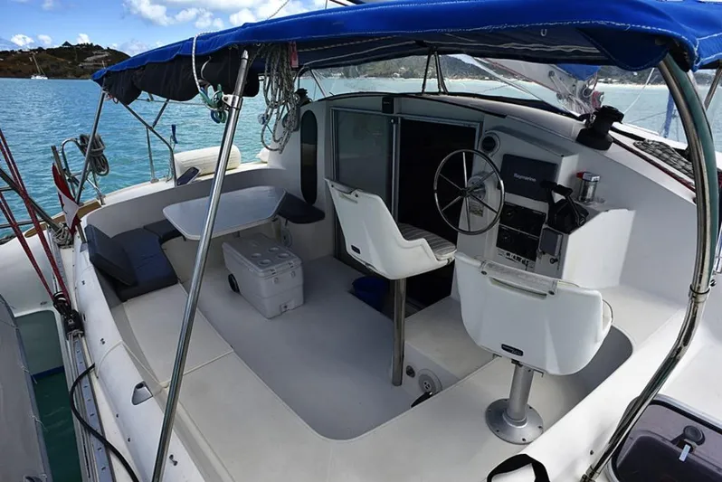 Mersea Yacht Photos Pics 1997 Fountaine Pajot Athena 38 catamaran cockpit with helm, seating, and ocean view.