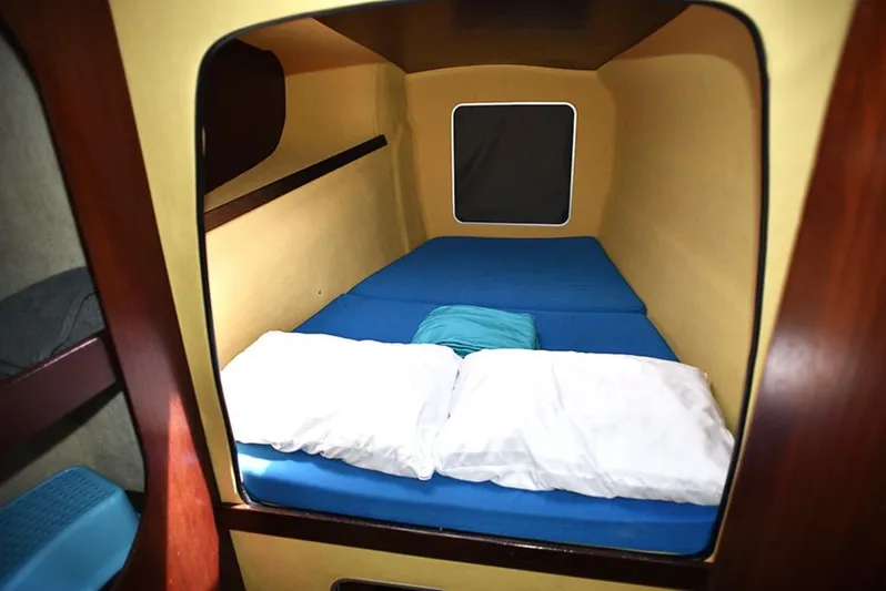 Mersea Yacht Photos Pics Cabin interior of 1997 Fountaine Pajot Athena 38 with blue bedding and pillows.