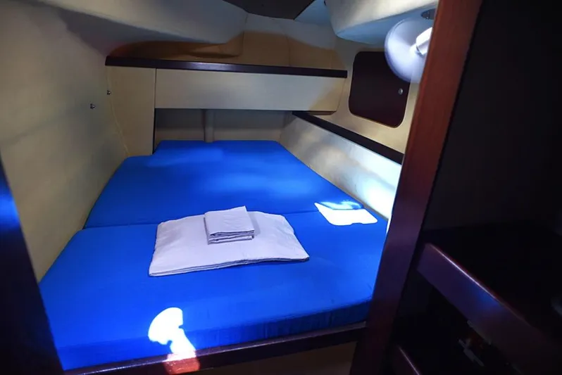 Mersea Yacht Photos Pics Cozy cabin interior of 1997 Fountaine Pajot Athena 38 with blue bedding.