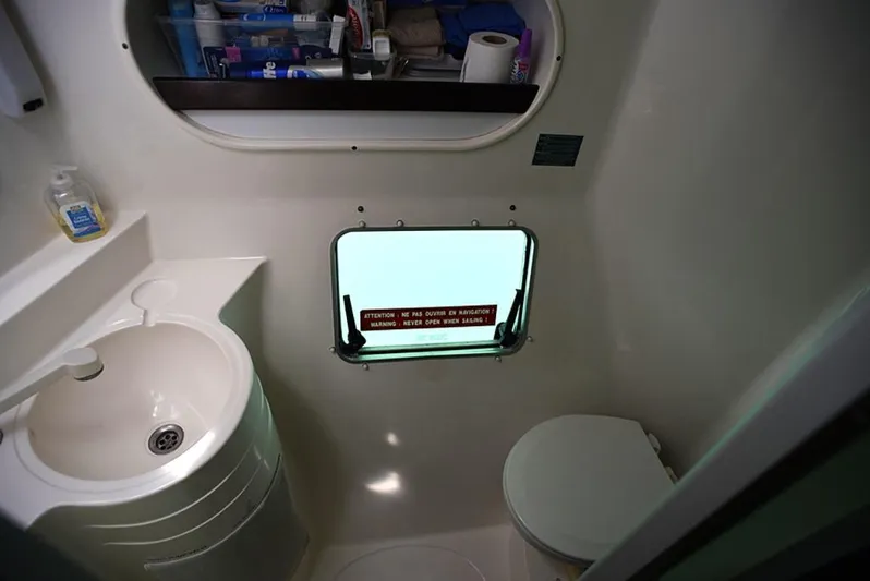 Mersea Yacht Photos Pics Bathroom interior of 1997 Fountaine Pajot Athena 38 catamaran, featuring sink and toilet.