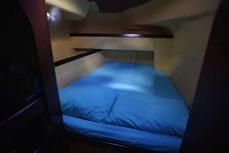 Mersea Yacht Photos Pics Cozy cabin interior of 1997 Fountaine Pajot Athena 38 with blue bedding.