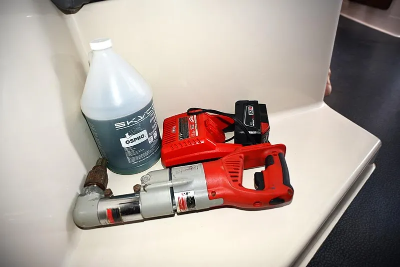 Mersea Yacht Photos Pics Red power tool and cleaning solution on Fountaine Pajot Athena 38 yacht interior.