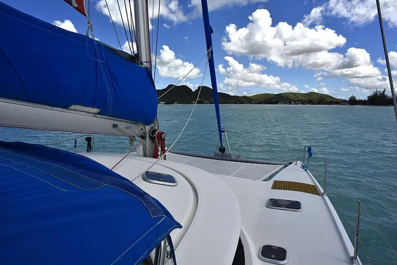 Mersea Yacht Photos Pics Sailing on a 1997 Fountaine Pajot Athena 38 catamaran with blue sails, under a partly cloudy sky.