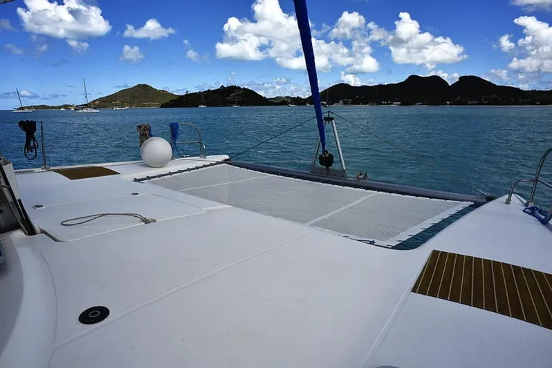 Mersea Yacht Photos Pics 1997 Fountaine Pajot Athena 38 catamaran on serene blue waters with island backdrop.
