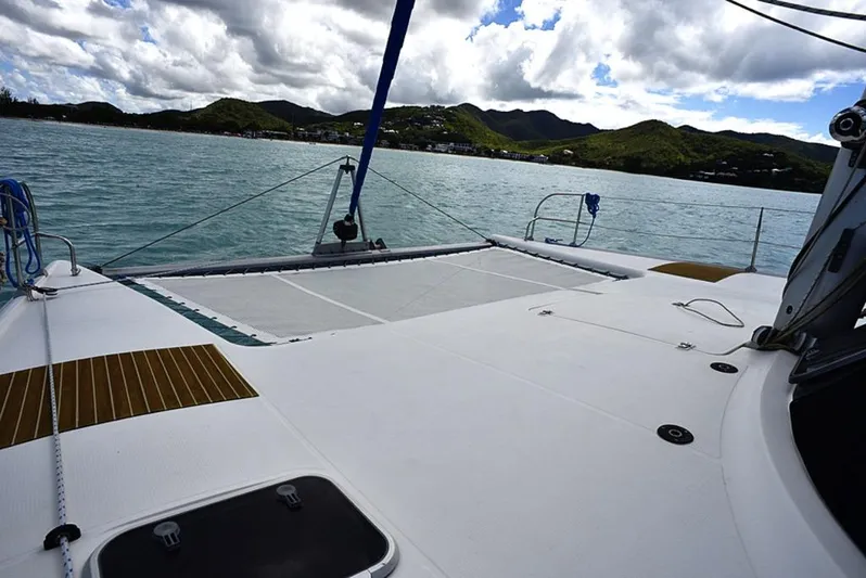 Mersea Yacht Photos Pics 1997 Fountaine Pajot Athena 38 catamaran on calm waters with scenic mountain backdrop.