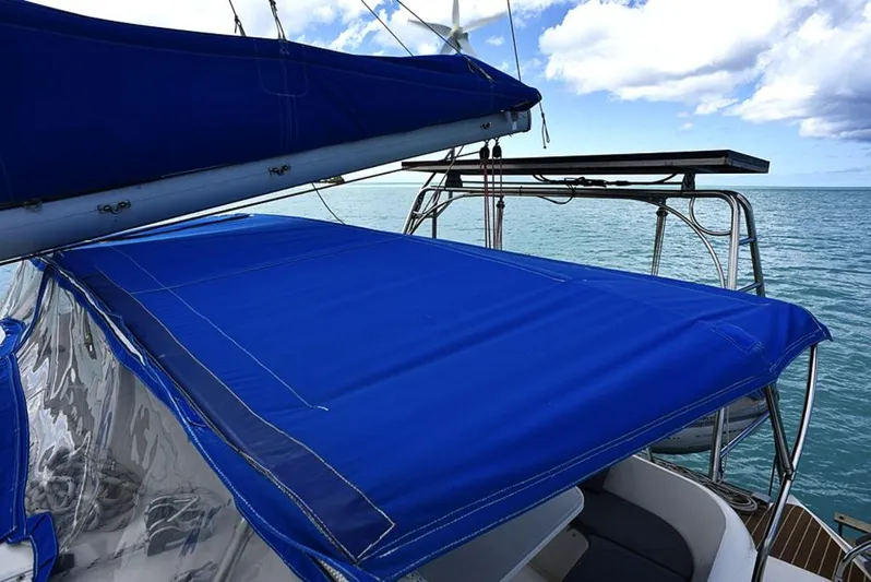 Mersea Yacht Photos Pics Fountaine Pajot Athena 38 sailboat with blue canopy, ocean view, 1997 model.