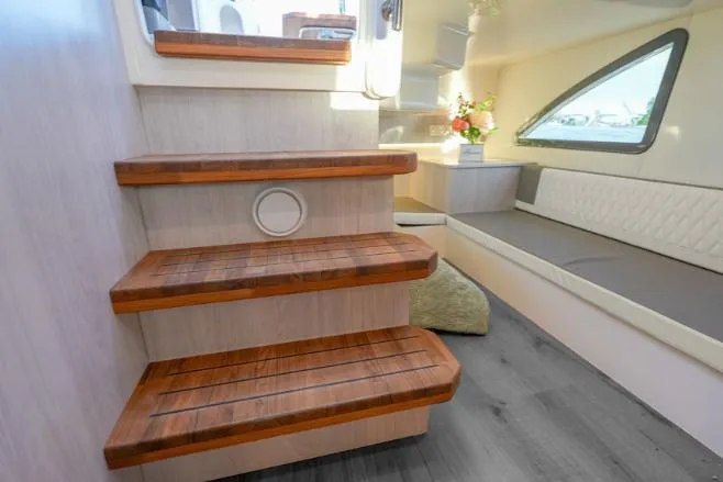 Ready For Immediate Delivery Yacht Photos Pics Interior of 2025 Hanover 387 Grey & Black Edition Outboard, featuring wooden steps and seating area.