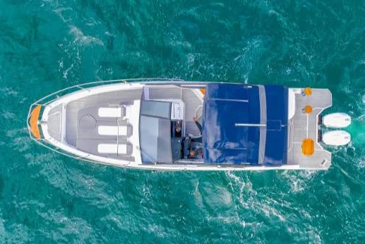 Ready For Immediate Delivery Yacht Photos Pics Aerial view of 2025 Hanover 387 Grey & Black Edition Outboard on turquoise water.