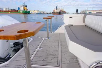 Ready For Immediate Delivery Yacht Photos Pics 2025 Hanover 387 Grey & Black Edition Outboard, featuring sleek seating and wooden table on deck.