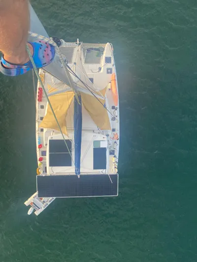 Hh Sound Waves Yacht Photos Pics Aerial view of 2008 Lagoon 420 Hybrid catamaran with solar panels on calm water.