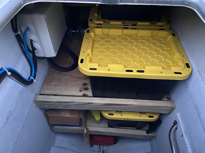 Hh Sound Waves Yacht Photos Pics Storage compartment in a 2008 Lagoon 420 Hybrid with yellow-lidded containers and electrical components.