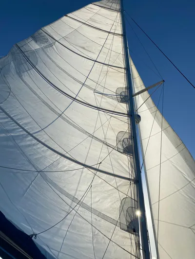 Hh Sound Waves Yacht Photos Pics Sail of 2008 Lagoon 420 Hybrid catamaran against clear blue sky.