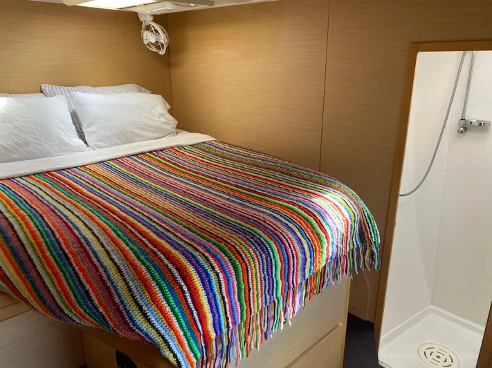 Hh Sound Waves Yacht Photos Pics Cozy cabin interior of 2008 Lagoon 420 Hybrid with colorful striped blanket and adjacent shower.
