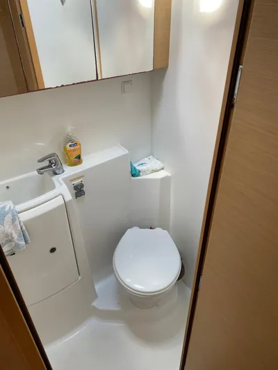 Hh Sound Waves Yacht Photos Pics Compact bathroom in a 2008 Lagoon 420 Hybrid yacht, featuring a toilet and sink.