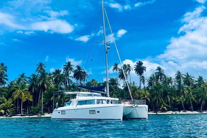 Hh Sound Waves Yacht Photos Pics 2008 Lagoon 420 Hybrid catamaran anchored near tropical palm-lined shore.
