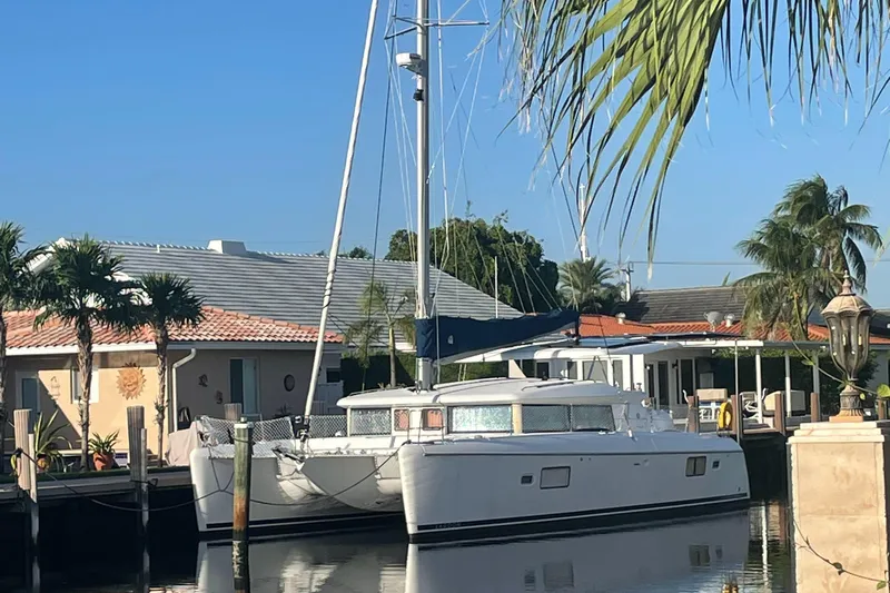 Hh Sound Waves Yacht Photos Pics 2008 Lagoon 420 Hybrid catamaran docked by tropical waterfront homes.