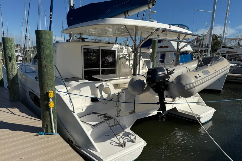 Way Maker Yacht Photos Pics 2010 Leopard 38 catamaran docked with inflatable boat and Mercury outboard motor.