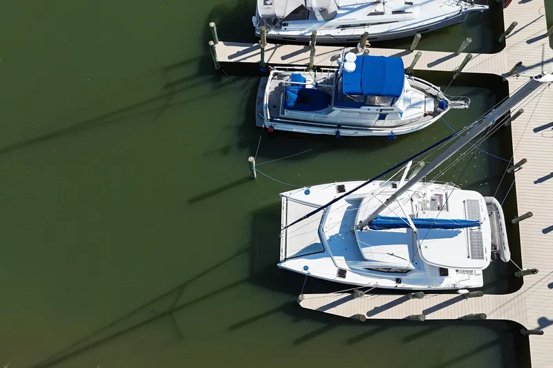 Way Maker Yacht Photos Pics Aerial view of a 2010 Leopard 38 catamaran docked at a marina.