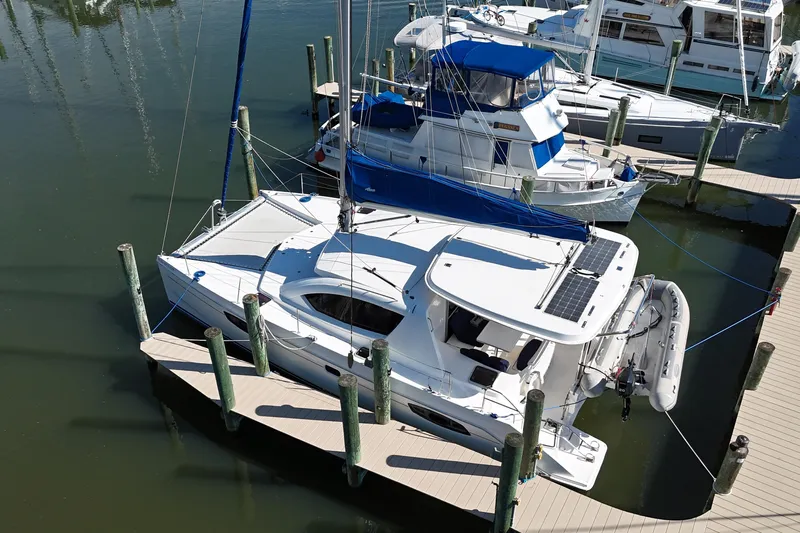 Way Maker Yacht Photos Pics 2010 Leopard 38 catamaran docked at marina, featuring solar panels and inflatable dinghy.