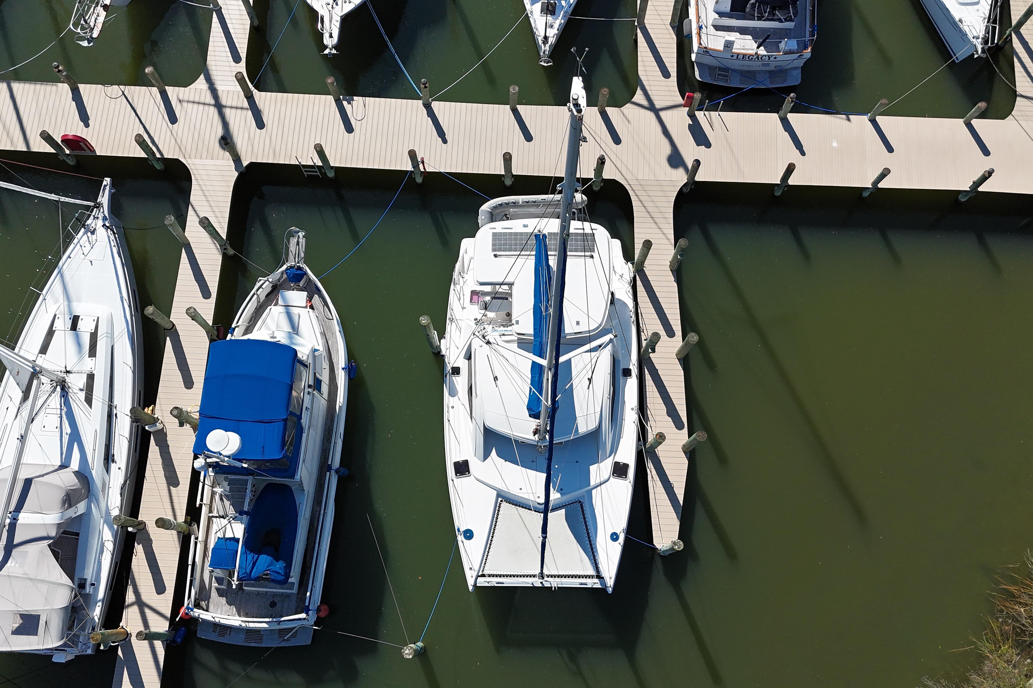 Aerial view of a 2010 Leopard 38 catamaran docked among other boats.