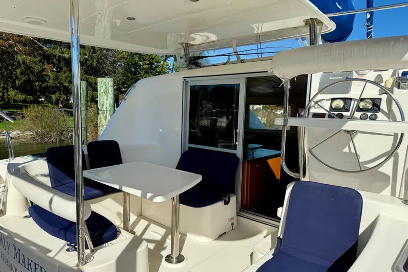 Way Maker Yacht Photos Pics 2010 Leopard 38 yacht cockpit with seating, table, and steering wheel.