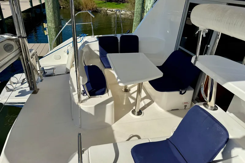 Way Maker Yacht Photos Pics 2010 Leopard 38 yacht deck with blue cushioned seating and table.