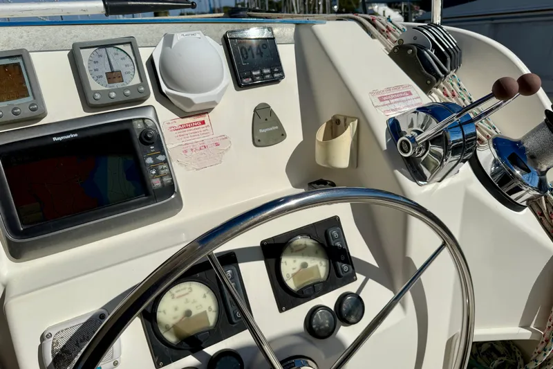 Way Maker Yacht Photos Pics Control panel of a 2010 Leopard 38 yacht with navigation instruments and steering wheel.