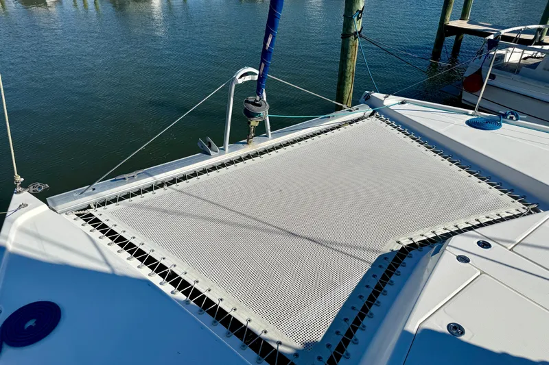 Way Maker Yacht Photos Pics 2010 Leopard 38 catamaran with netting on deck, docked by calm water.
