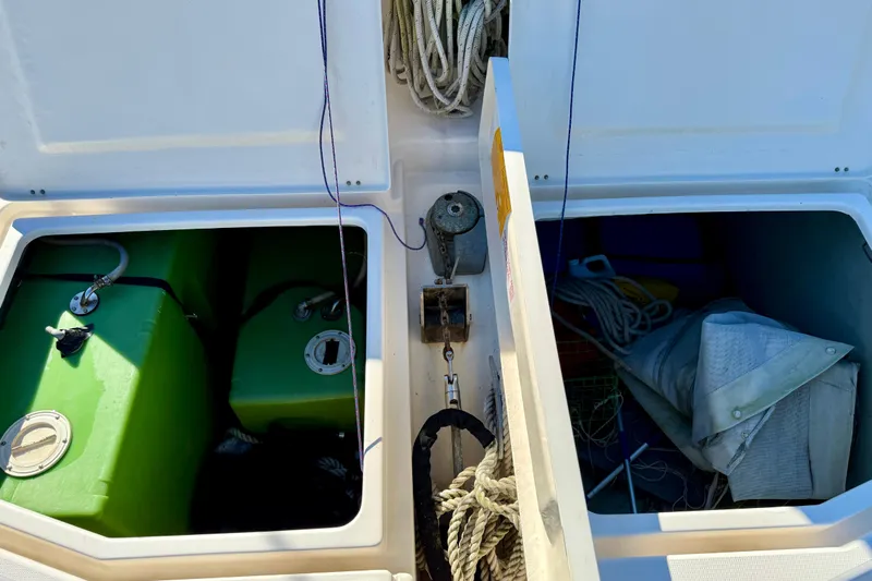 Way Maker Yacht Photos Pics Storage compartments on a 2010 Leopard 38 catamaran with green tanks and sailing equipment.