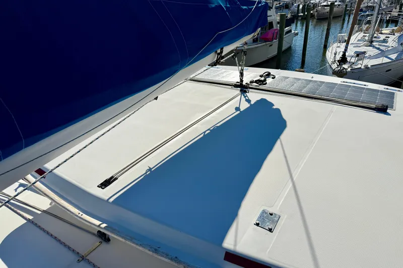 Way Maker Yacht Photos Pics 2010 Leopard 38 catamaran deck with solar panels and blue sail, docked at marina.