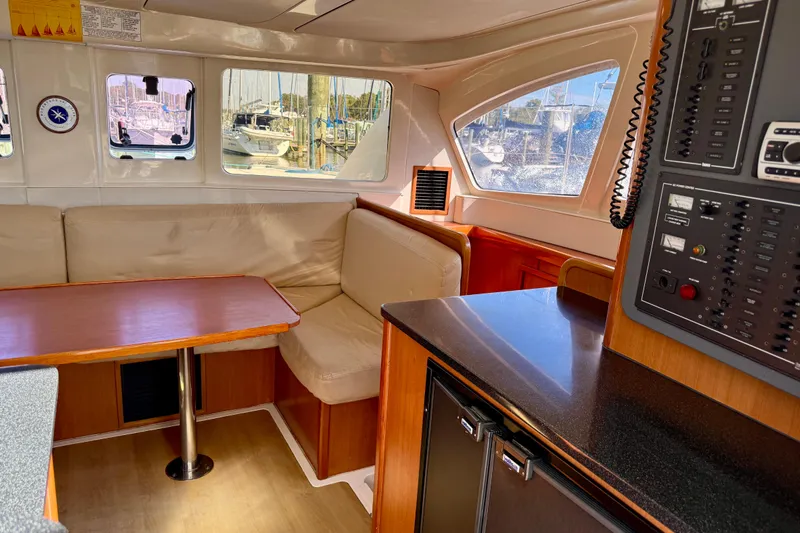 Way Maker Yacht Photos Pics Interior of 2010 Leopard 38 yacht with seating, table, and control panel.