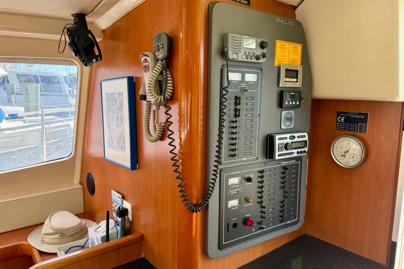 Way Maker Yacht Photos Pics Control panel inside a 2010 Leopard 38 yacht, featuring communication devices and gauges.