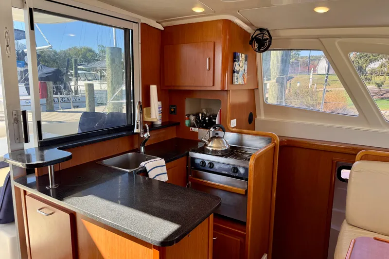 Way Maker Yacht Photos Pics Modern kitchen in 2010 Leopard 38 yacht with stove, sink, and ample counter space.