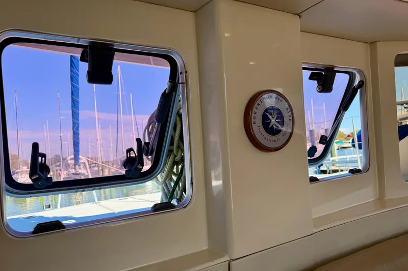 Way Maker Yacht Photos Pics Interior view of a 2010 Leopard 38 catamaran with marina backdrop through windows.