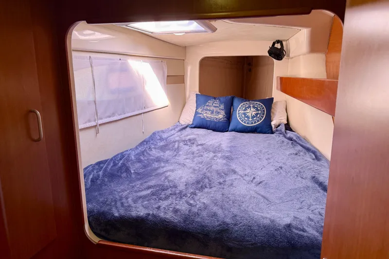 Way Maker Yacht Photos Pics Cozy cabin interior of 2010 Leopard 38 catamaran with nautical-themed bedding.