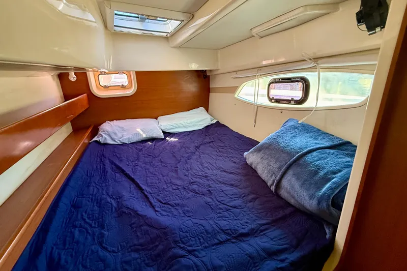 Way Maker Yacht Photos Pics Cozy cabin interior of 2010 Leopard 38 yacht with bed and windows.