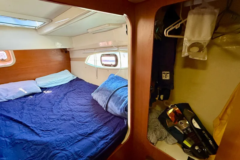 Way Maker Yacht Photos Pics Cozy cabin interior of 2010 Leopard 38 catamaran with bed and storage space.
