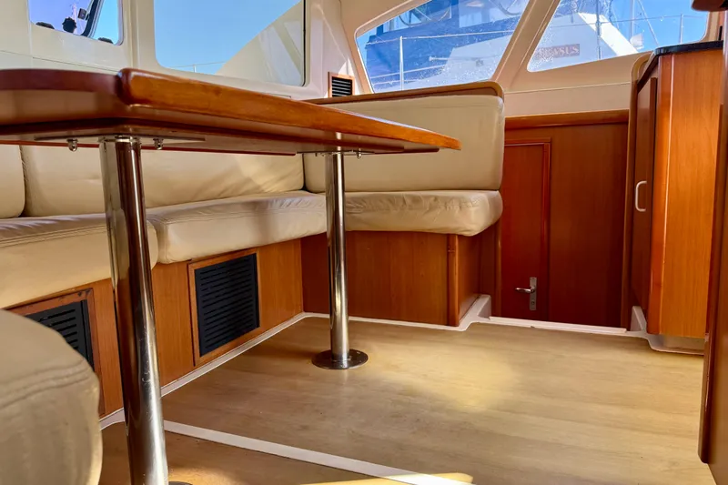 Way Maker Yacht Photos Pics Interior of 2010 Leopard 38 yacht with wooden furnishings and cushioned seating.