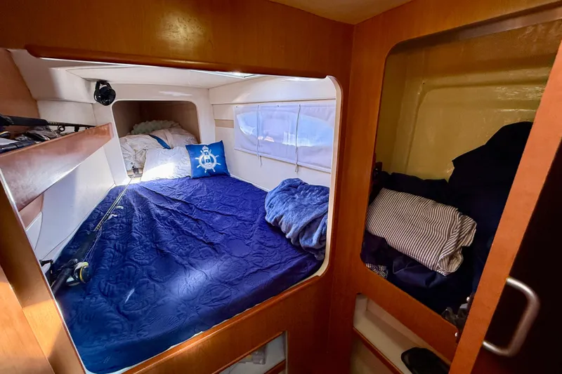 Way Maker Yacht Photos Pics Cozy cabin interior of 2010 Leopard 38 catamaran with blue bedding and nautical decor.